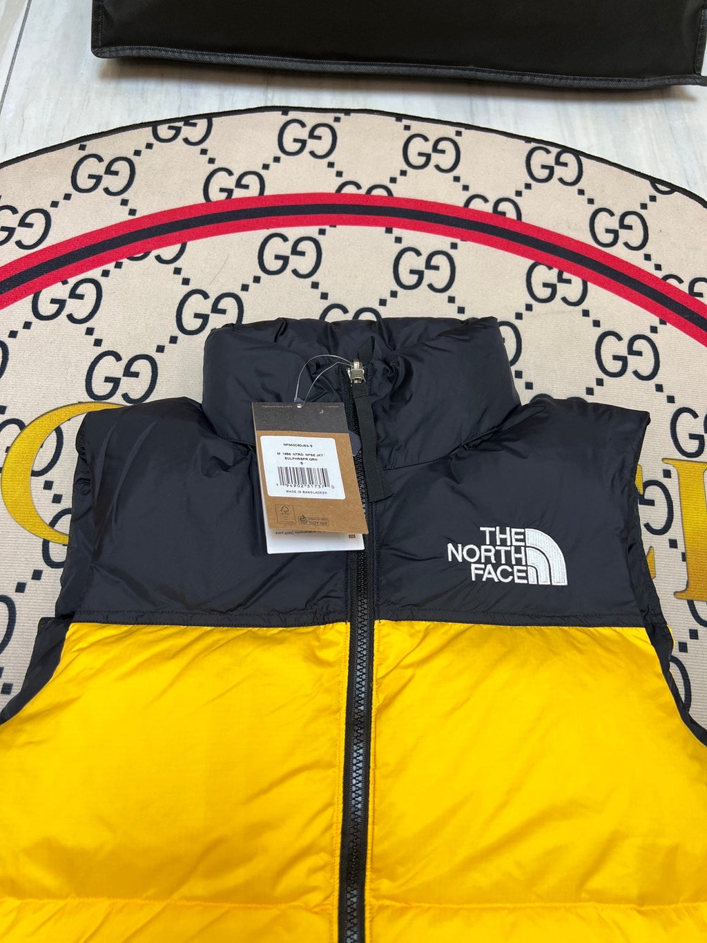The North Face Puffer Vest in Yellow and Black with Stand Collar